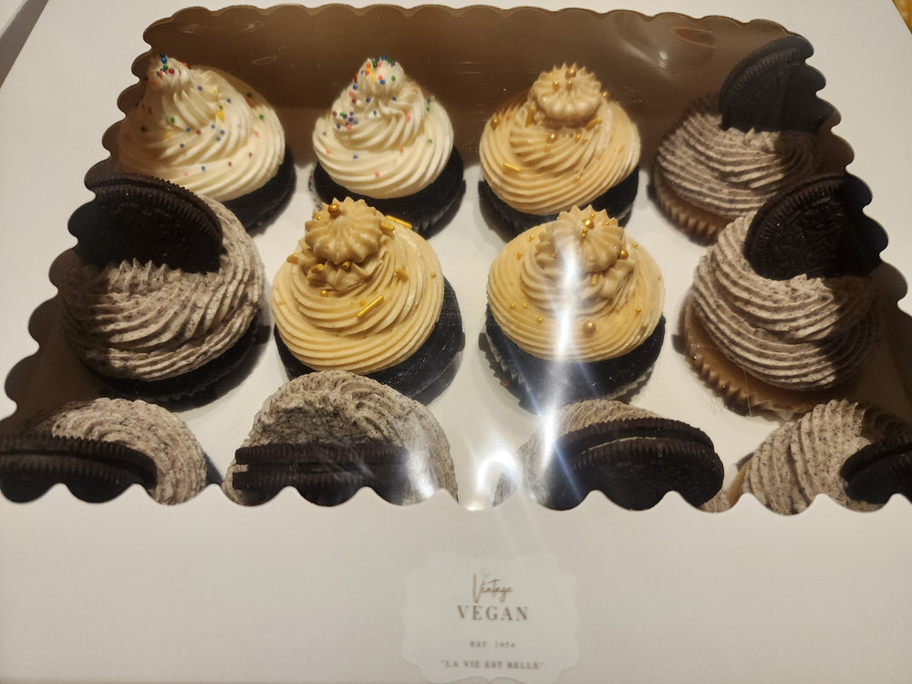 A dozen Vintage Vegan cupcakes in a signature box: Oreo cookies-and-cream, peanut butter cream and rainbow sprinkle vanilla