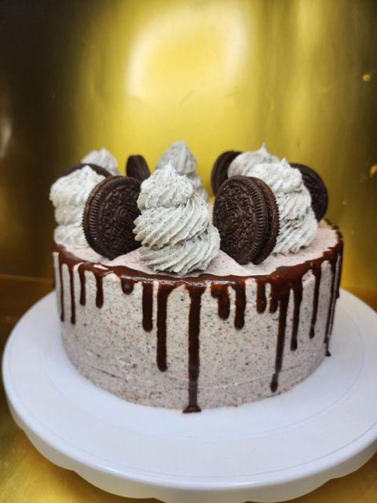 Cookies and cream drip cake topped with Oreo cookies