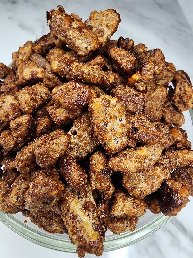 Glass bowl of candied pecans